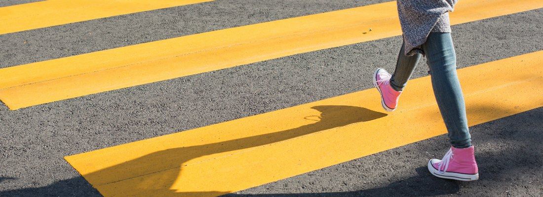 Girl Crossing a Street Using a Crosswalk